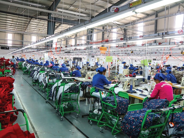 Many women are working in a cloth manufacturing factory 